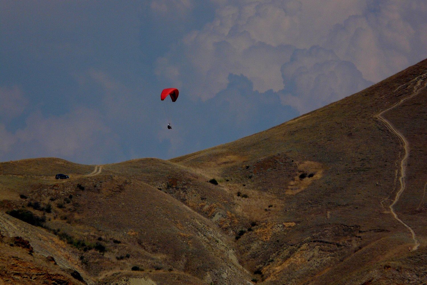 Paraglider above mountains